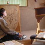 girl praying in chapel