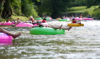 people floating down a river in inner tubes