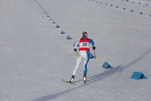 Cross country skiing race, skier rear view