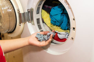 Handful of lint trapped in filter of laundry dryer clothes machine after drying