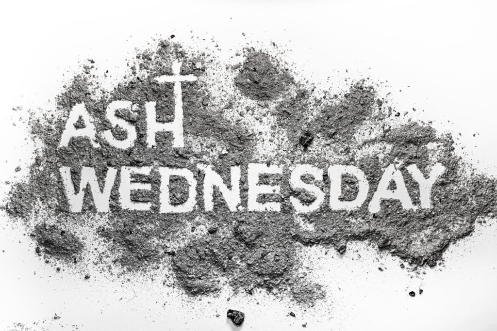 Ash wednesday word written in ash and christian cross