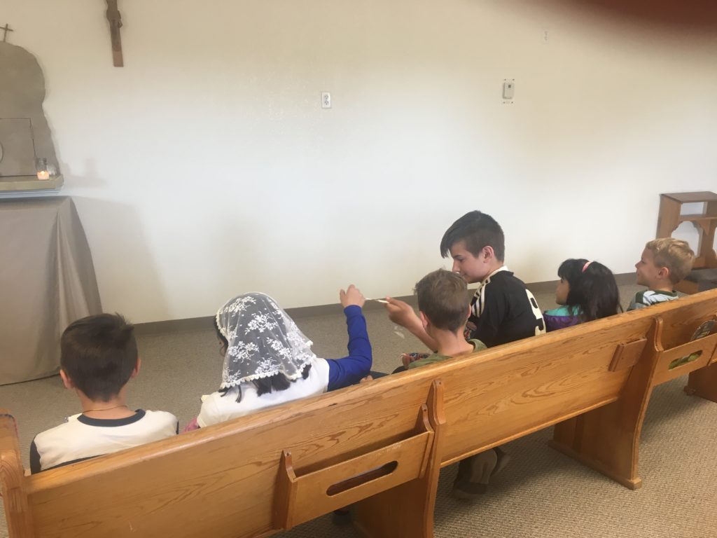 children praying in church